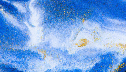Closeup dust of pigment sparkling with blue fluid color