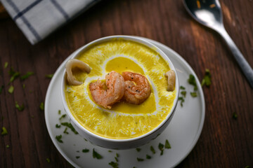 Seafood soup in a white bowl with shrimp and calamari