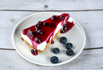 Fresh blueberry fruit cheese cake with jam and fruits on top