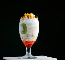Blended Fruit salad with kiwi, banana, apple, pomegranate and other fruits with Vanilla ice cream