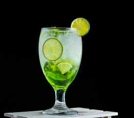 Refreshing green apple Mojito with lemon and sprinkled water in a glass