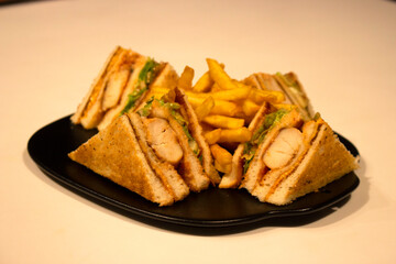 Chicken nugget sandwich combo with French fries in a plate