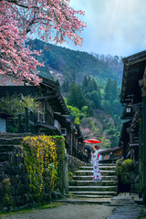 Old town of Tsumago juku in spring. Asian woman wearing japanese traditional kimono at Tsumago juku...