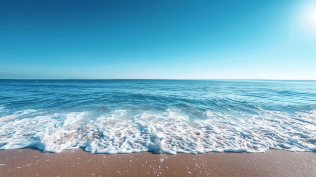 The ocean is calm and the sky is blue. The water is a deep blue color. The sky is clear and the sun is shining