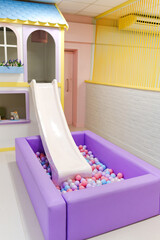 A children's slide with a dry ball pool for a children's center. 