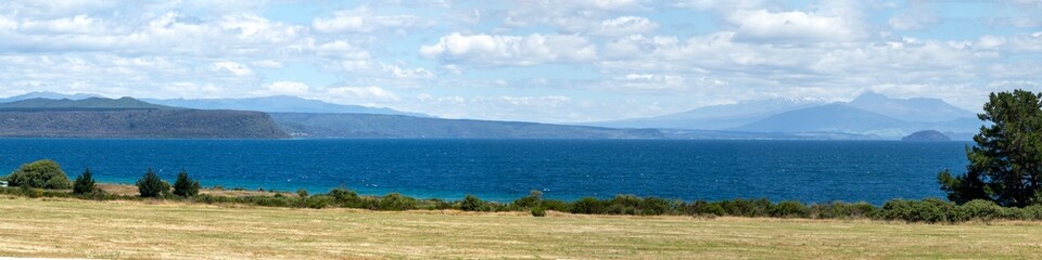 Panoramic view from Lake Taupo lookout: turquoise waters of the crater lake against the stunning...