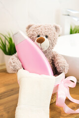 Various bath accessories for children and cute toys on table in bright bathroom, close-up....