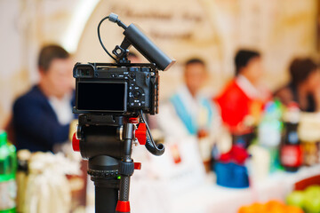 A professional camera on a tripod shoots a video of a Korean holiday.