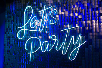Lets party inscription on the glitter wall. Holiday decor. 