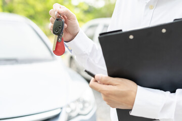 lease, rental car, sell, buy. Dealership manager send car keys to the new owner.  Sales, loan...