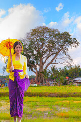 Portrait of balinese girl in traditional costume -  Large Banyan tree in Kayu Putih Tourism is located in Baru Village, Marga District - Tabanan Regency, Bali