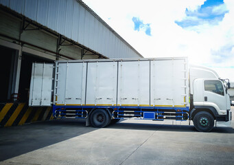 Container Trucks Loading at Dock Warehouse. Container Shipping. Distribution Warehouse Shipping....
