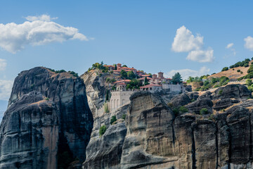 Historical monastery sitting on the edge of a massive rock cliff in Meteora Greece