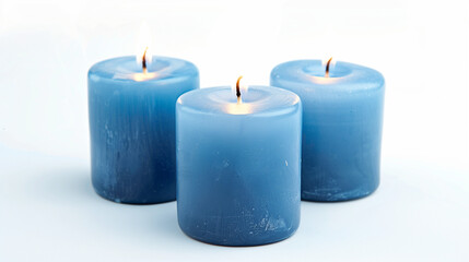 Fototapeta na wymiar Three wide blue candles close together on white background