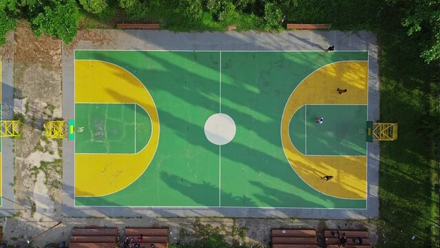 view of the basketball court from above and there are several basketball players playing basketball in outdoor