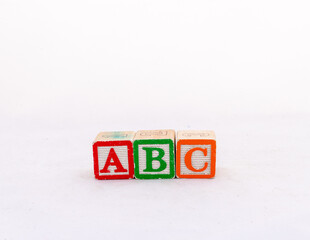 A, B and C wooden blocks isolated on white background with copy space.