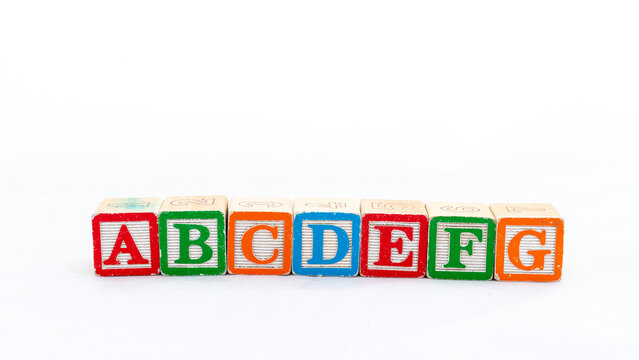 ABCDEFG wooden letter blocks isolated on white background