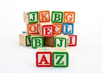 Wooden toy cubes with letters. Alphabet A and Z are in focused and the rest are blurred