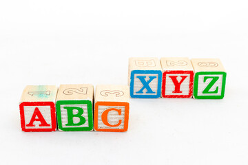 ABC and XYZ wooden alphabet blocks isolated on white background