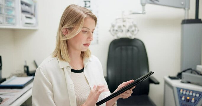 Tablet, ophthalmology and woman optician in store for eye exam with vision, eye care or health. Research, optometry and female optometrist typing information on digital technology in optical shop.