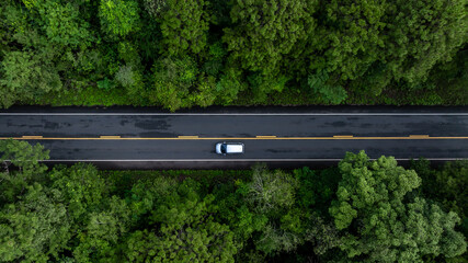Aerial view electric vehicle car or EV car on green forest road, EV car travel in green season,...