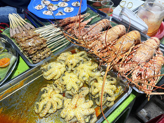 Seafood grilled seafood with fresh lobster , Scallops , Pork ,chicken , oysters as an ocean gourmet...