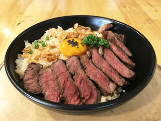 Beef Fried Rice with eggs and vegetables in black bowl