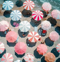 Summer at the beach comes to life in this aerial image featuring sunbathers and colorful umbrellas on white sands