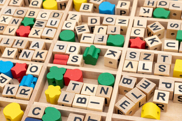 scattered alphabet wooden blocks in a box