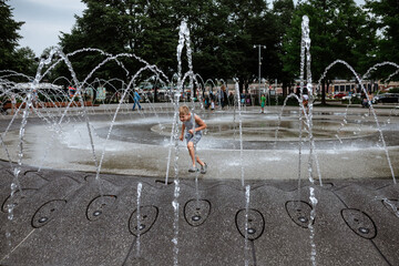 Child playing in city fountain in Chicago Illinois