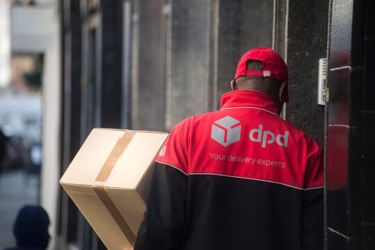 Brussels - Belgium - 30 February 2024 - portrait on back view of DPD delivery man working in the street