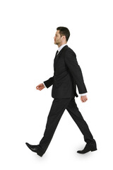 A businessman in a black suit walking on white background, ideal for business-related design...