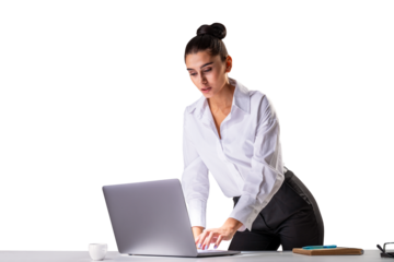 A businesswoman leaning over a table, working on a laptop with a coffee cup and notebook nearby, isolated on a white background, showcasing a concept of professionalism