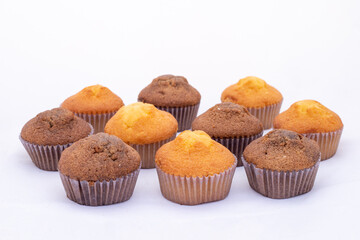 Fresh tasty chocolate muffins cakes on white isolated background.