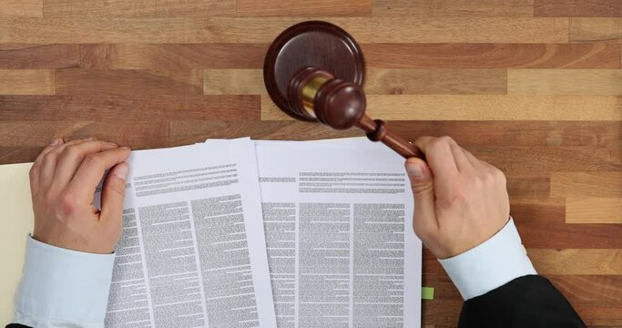 Judge knocks gavel and announces the court's decision top view