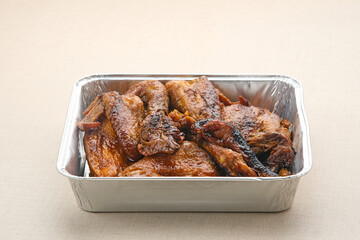 Ayam Bakar, roasted chicken with herbs and spice. Served with chilli paste and cucumber. Indonesian food
