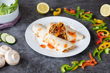 Tortilla: A thin flatbread made from finely ground wheat or corn flour, a staple in Mexican and Central American cuisine, often used as a base for tacos, burritos, and enchiladas.