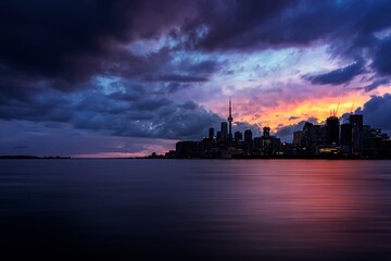 City skyline at sunset with red sky and clouds in Toronto