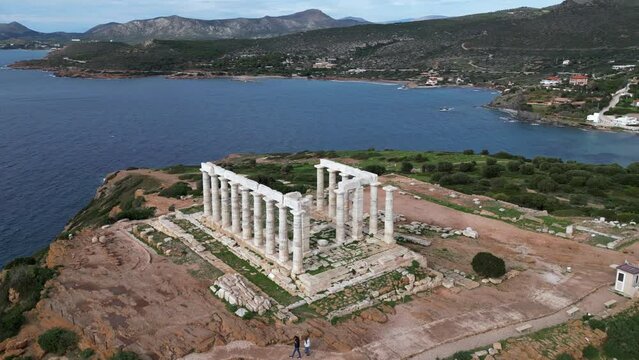 Temple of Poseidon is one of the most famous monuments in Greece , perched on a rocky promontory overlooking the Egean Mediterranean  sea , Cape Sounion - drone aerial view of Unesco Heritage world 