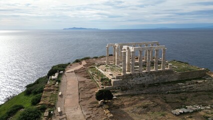 Fototapeta na wymiar Temple of Poseidon is one of the most famous monuments in Greece , perched on a rocky promontory overlooking the Egean Mediterranean sea , Cape Sounion - drone aerial view of Unesco Heritage world 