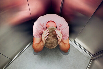 Man Suffering From Claustrophobia Trapped Inside Elevator