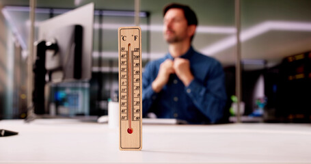 Thermometer In Front Of Businessman Working During Hot Weather