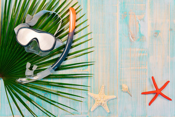 Composition concept summer vacation, beach diving, starfish with diving goggles and snorkel tube on...