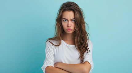 Photo of unhappy upset doubtful young woman hold hands crossed bad mood dislike , on pastel blue background
