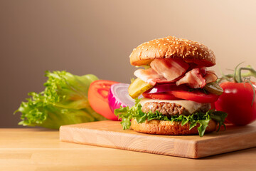 Fresh tasty burger on a wooden cutting board.