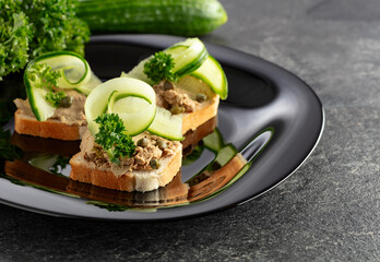 Open sandwiches with pate, fresh cucumber, capers, and parsley.