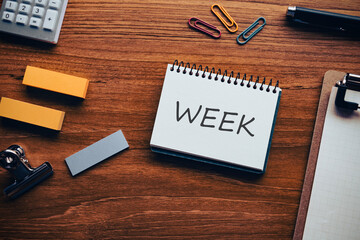 There is notebook with the word WEEK. It is as an eye-catching image.