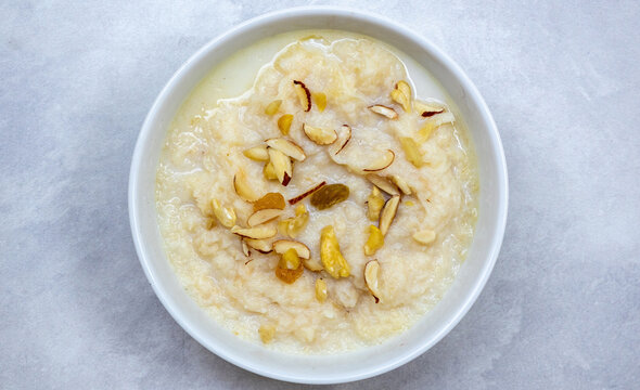 Delicious homemade laccha semai in a white bowl. Made with milk, sugar, or jaggery, cashew nuts, almonds, and raisins. Top view