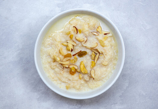 Delicious homemade laccha semai in a white bowl. Cooked with milk, sugar, or jaggery, is served with cashew nuts, almonds, and raisins. Top view