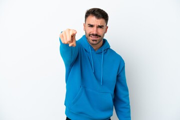 Obraz premium Young caucasian man isolated on white background frustrated and pointing to the front
